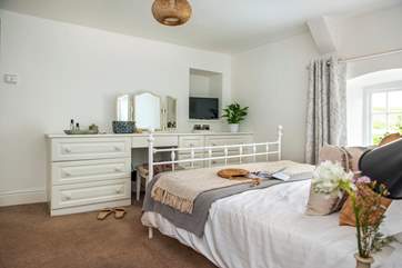 A wonderfully light and airy room with plenty of storage.