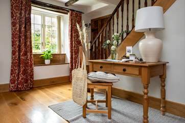 The doorway by the stairs leads from one sitting-room into the other.