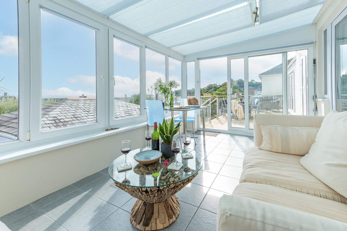 The gorgeous conservatory is ideal for taking shade or to take in the view during cooler months.