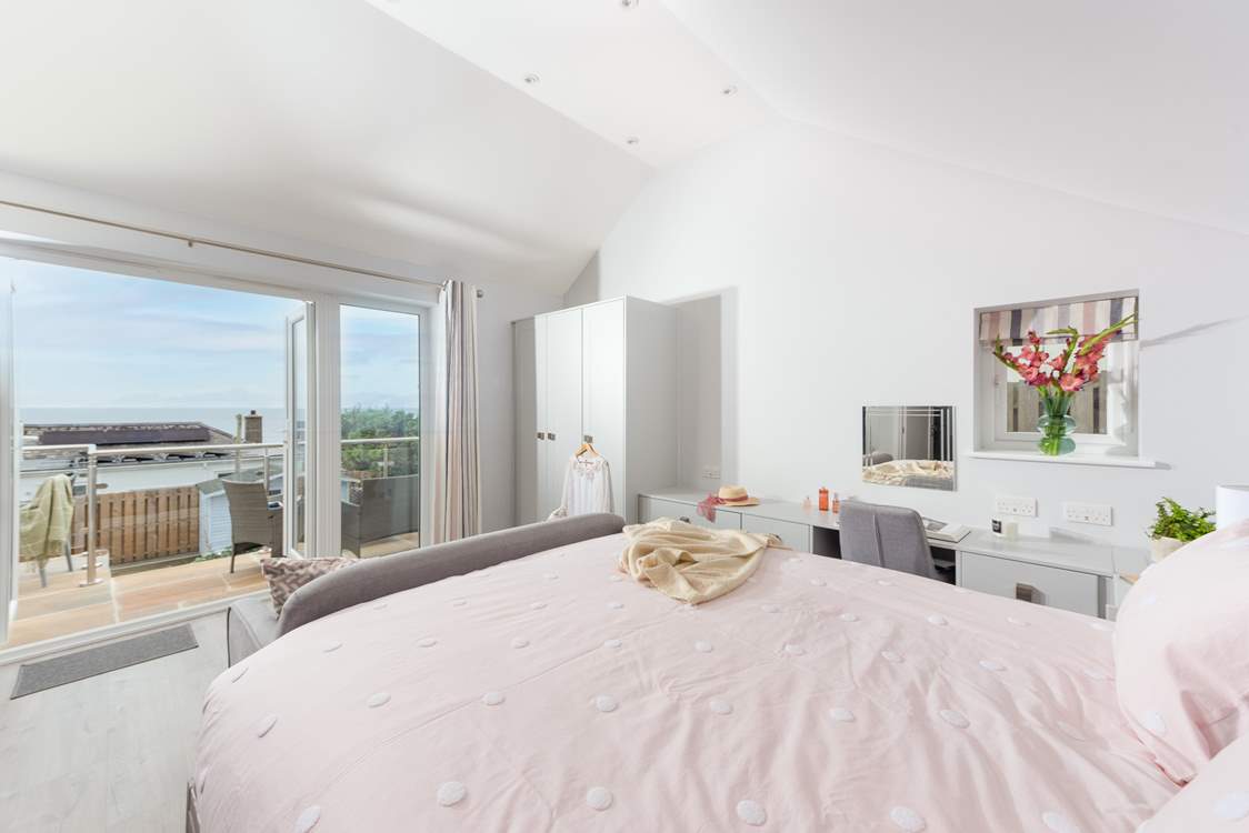 Bedroom 1 has a stunning view and direct access onto the patio.