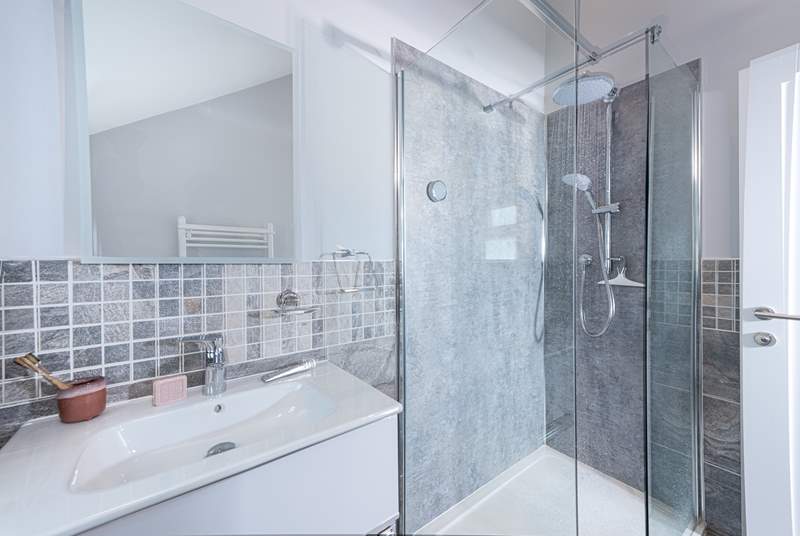 The super en suite to bedroom 1 has a rainfall shower, perfect for rinsing salty toes after a beach day.