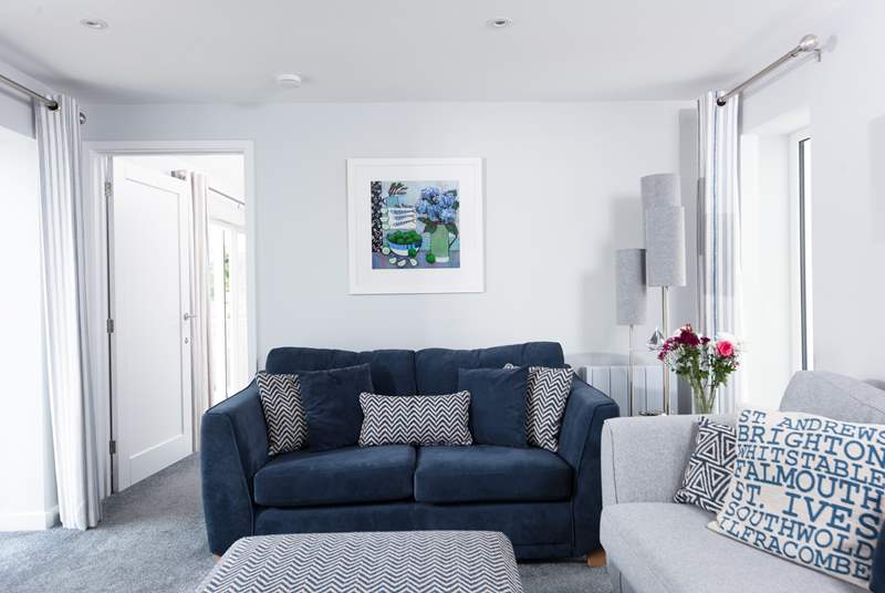 Giving a nod to the seaside location, the sitting-area is furnished in cool shades of blue and grey.
