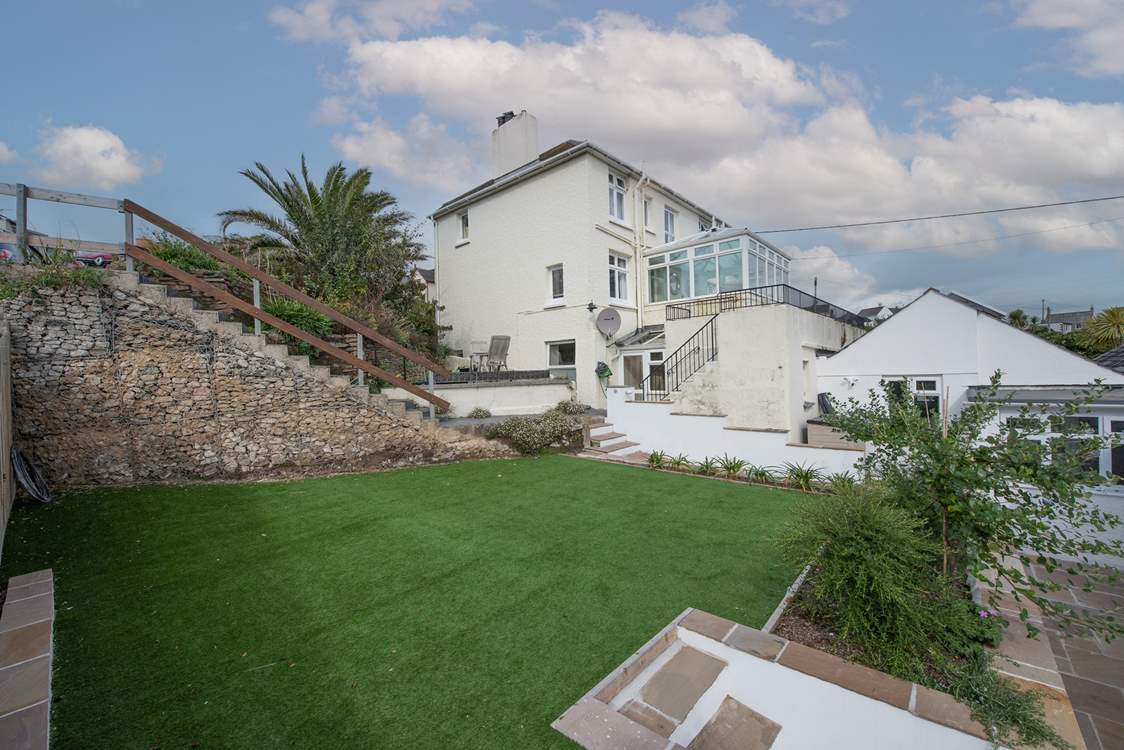 The steps lead down from the allocated parking space to Four Winds. Step access is shared with the house in the centre of the picture however the astro turf lawn at the rear belongs to Four Winds.