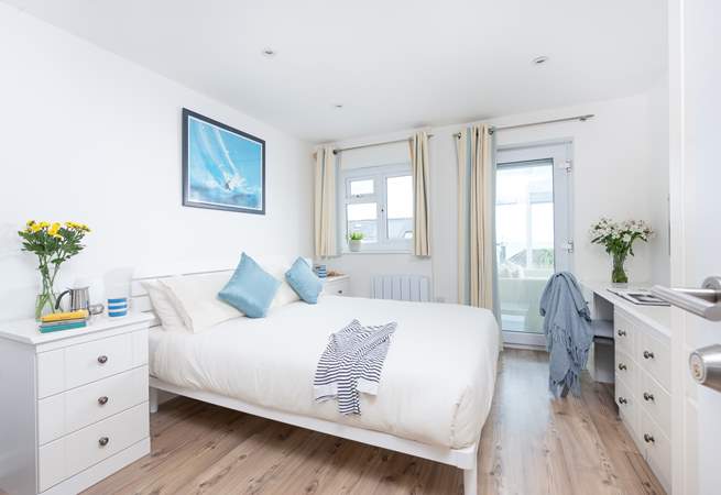 Bedroom 2 has a king-size double bed, access to the conservatory and an en suite shower-room.