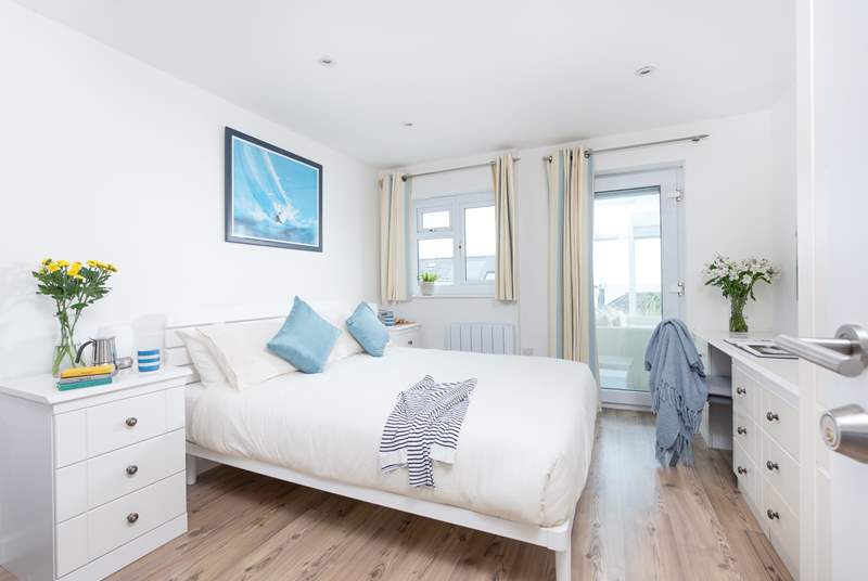 Bedroom 2 has a king-size double bed, access to the conservatory and an en suite shower-room.