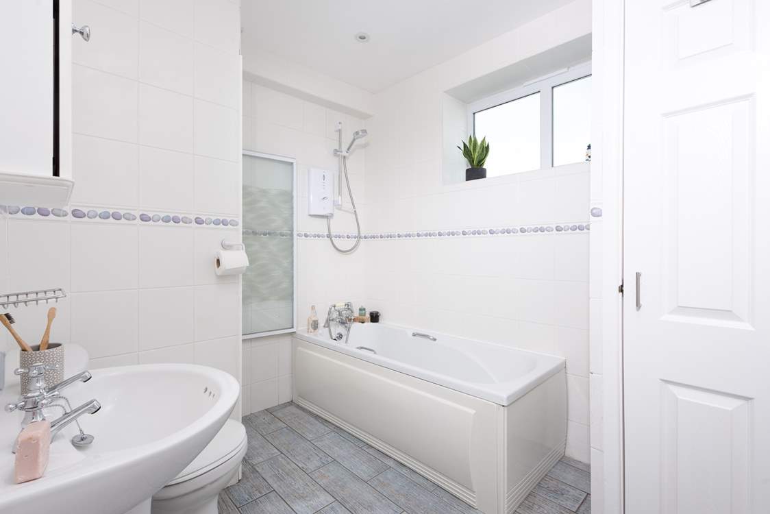 There is a step into the family bathroom where you will find a bath with a shower over.