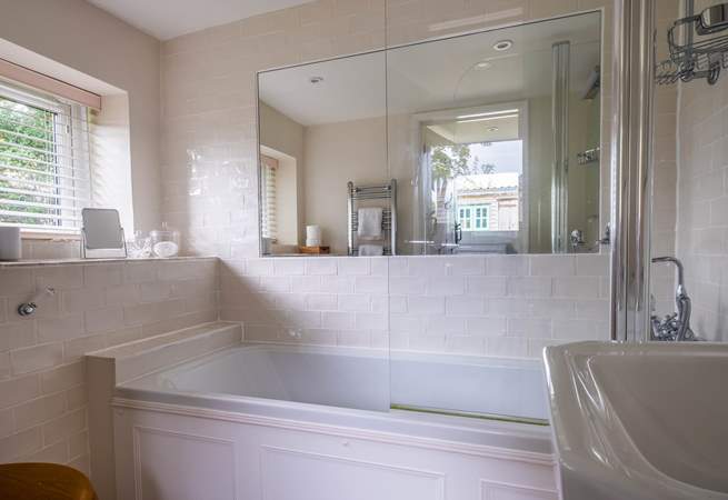 The ground floor bathroom has a bath with shower attachment.