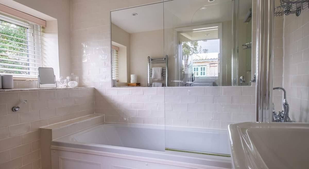 The ground floor bathroom has a bath with shower attachment.