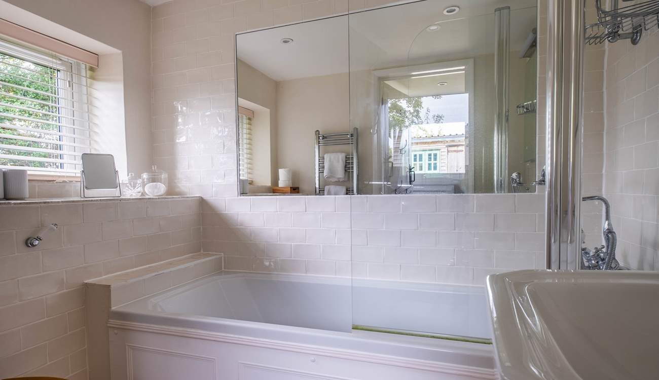 The ground floor bathroom has a bath with shower attachment.