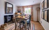 The dining-room has a wood-burner to keep you cosy in cooler months. - Thumbnail Image