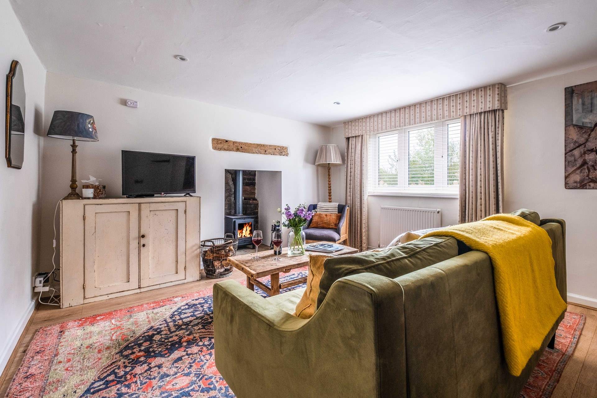 The warming wood-burner will keep you cosy year-round in the sitting-room.