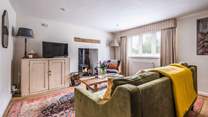 The warming wood-burner will keep you cosy year-round in the sitting-room.