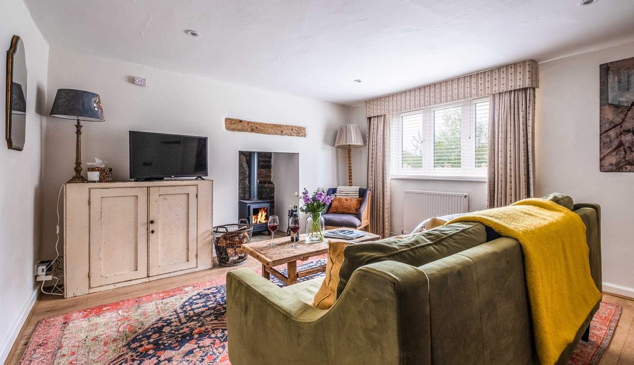 The warming wood-burner will keep you cosy year-round in the sitting-room.