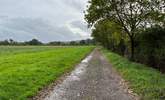 The long stone driveway to the cottage with views of the surrounding farmland. - Thumbnail Image