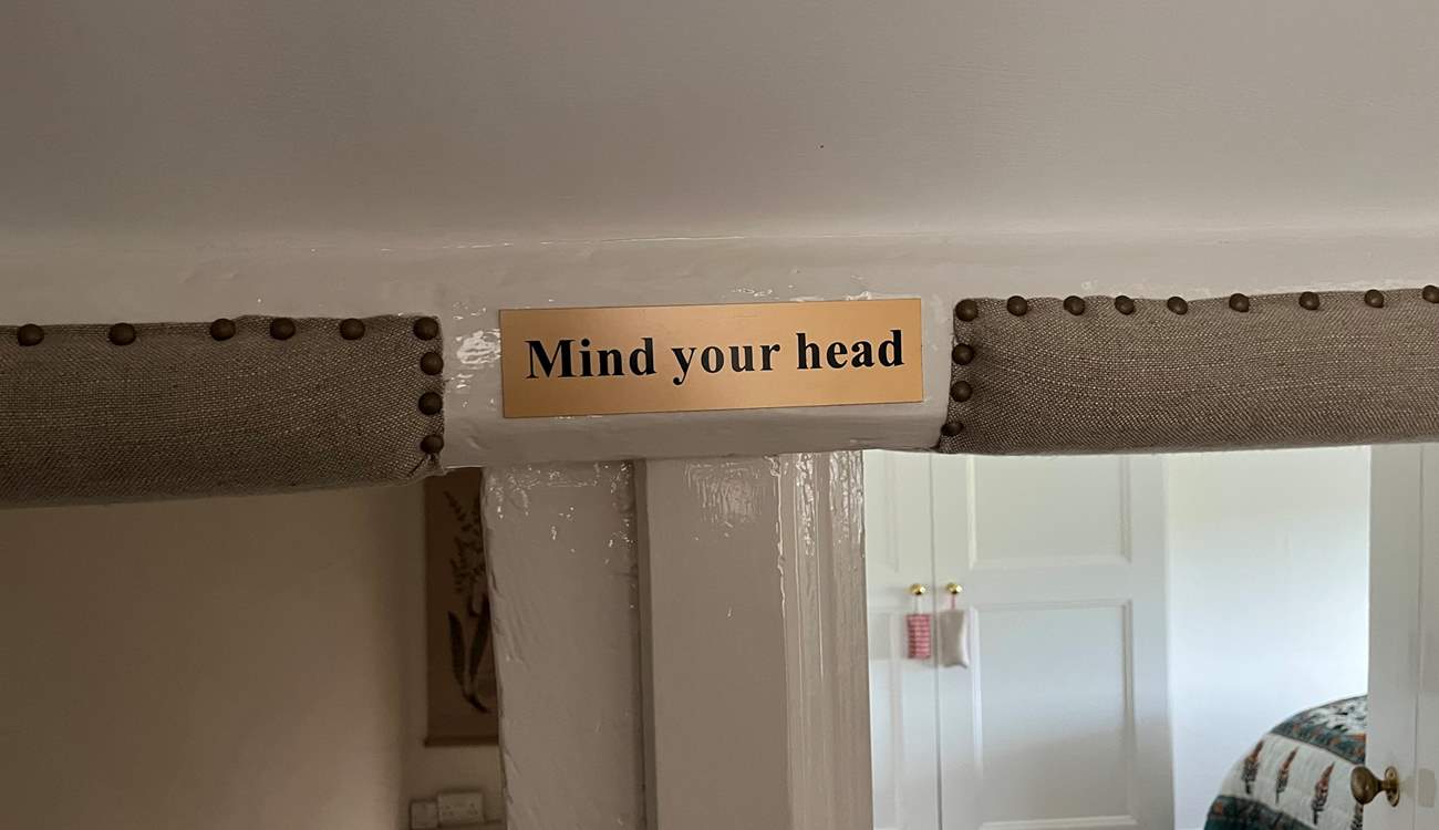 Please note that at the top of the stairs there is a low beam, and the bedroom doorways are low.