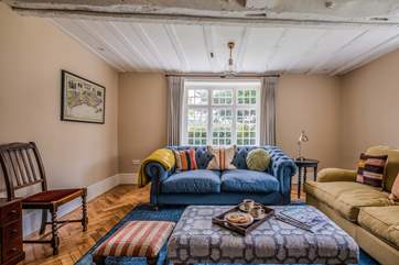 Comfy sofas invite you to relax in the gorgeous sitting-room.