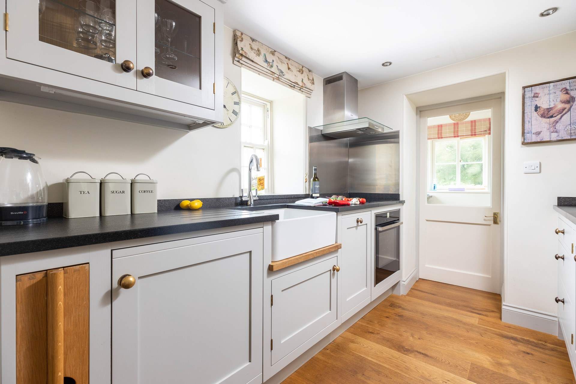 The stylish kitchen has an induction hob and a slimline dishwasher.