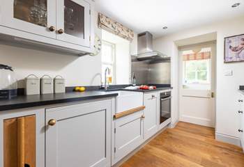 The stylish kitchen has an induction hob and a slimline dishwasher.