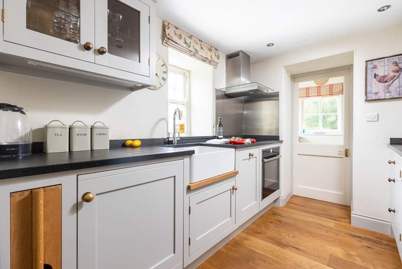 The stylish kitchen has an induction hob and a slimline dishwasher.
