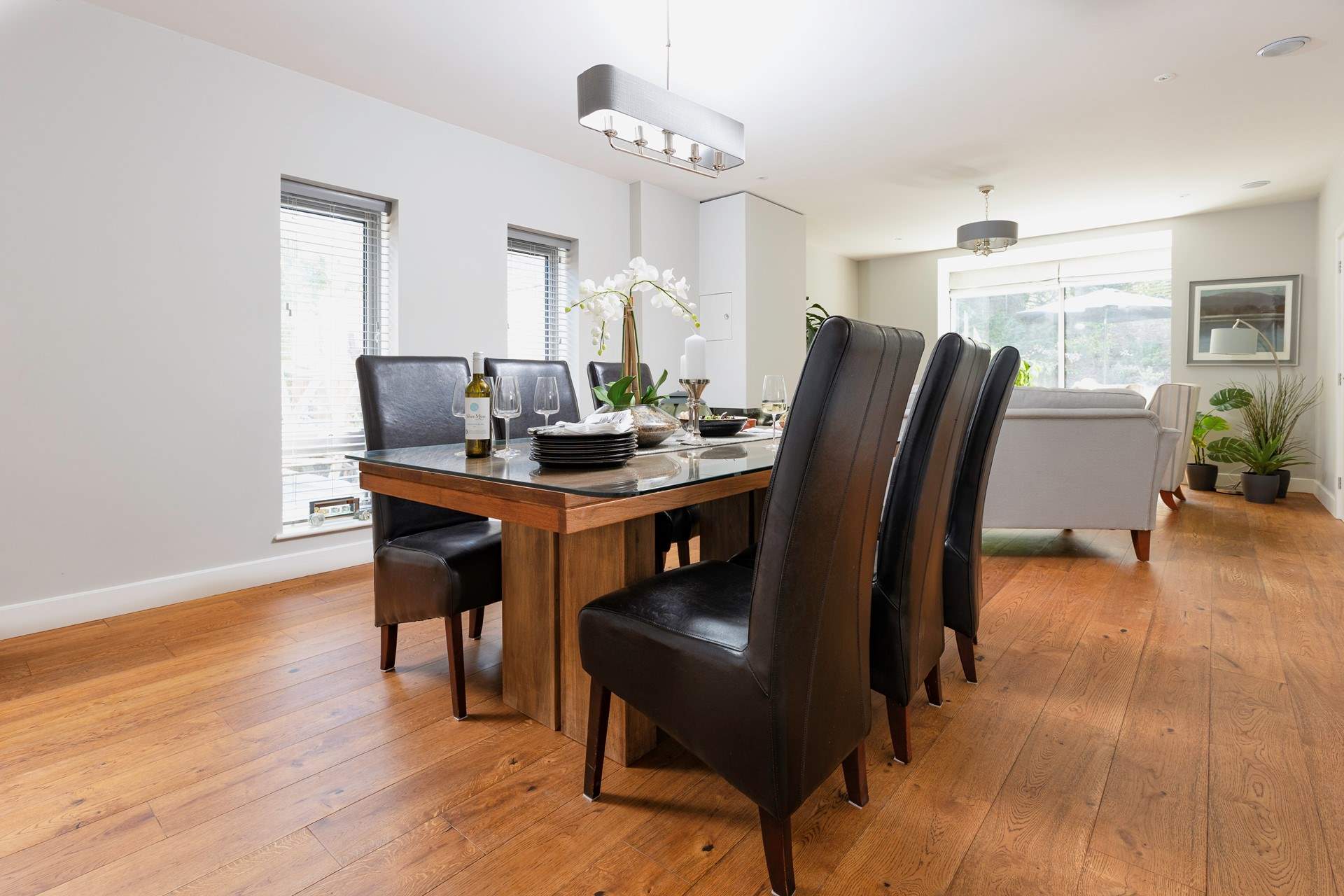 A beautiful wooden dining-table proudly sits in the corner of the room.