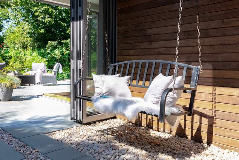 Delve into your favourite book on the charming swing bench.