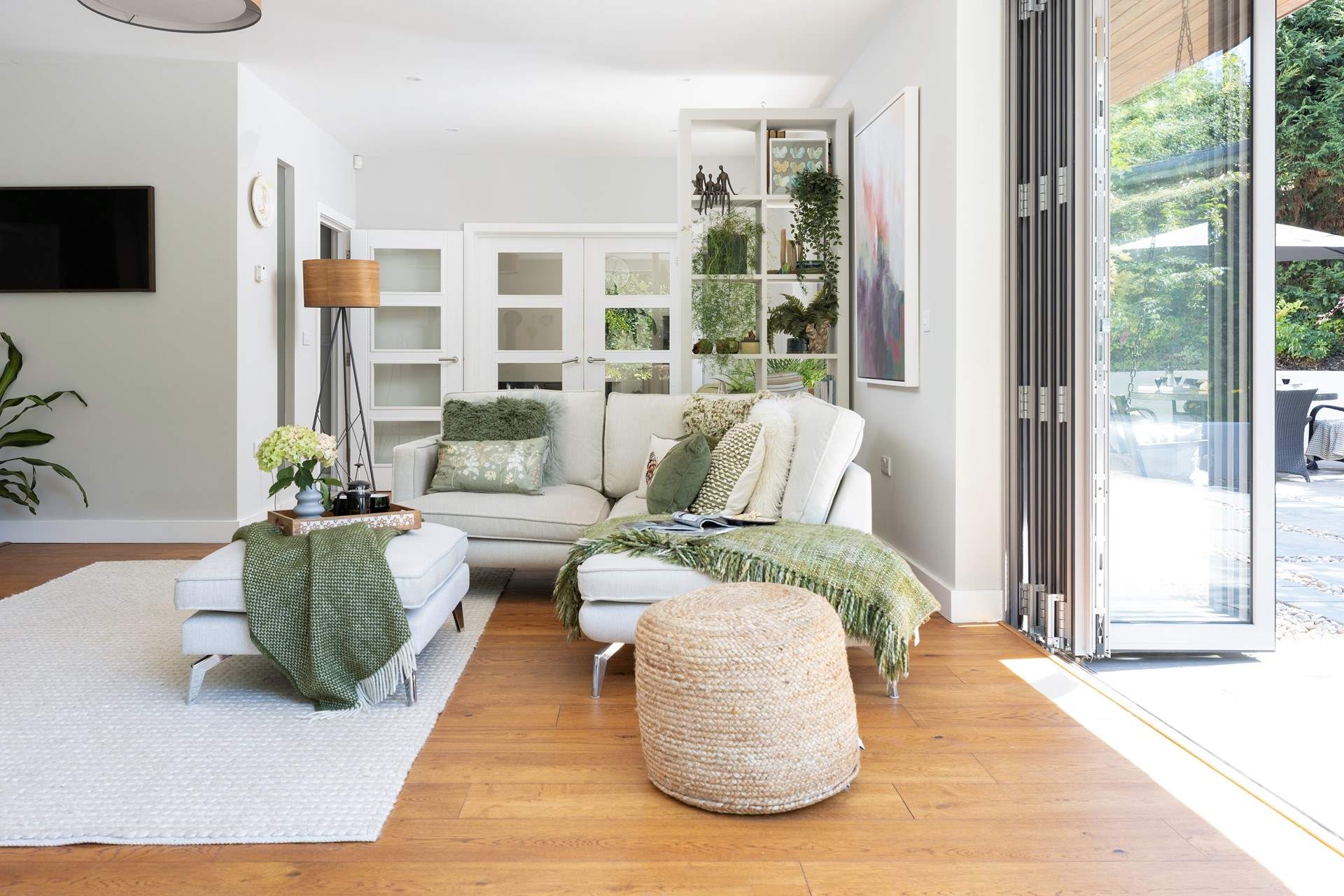 Bi-fold doors give the space a wonderful light and airy feel.