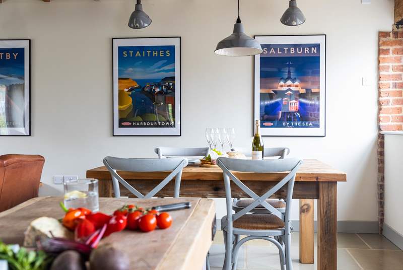 The dining area, with its reclaimed dining-table, is situated next to the kitchen.