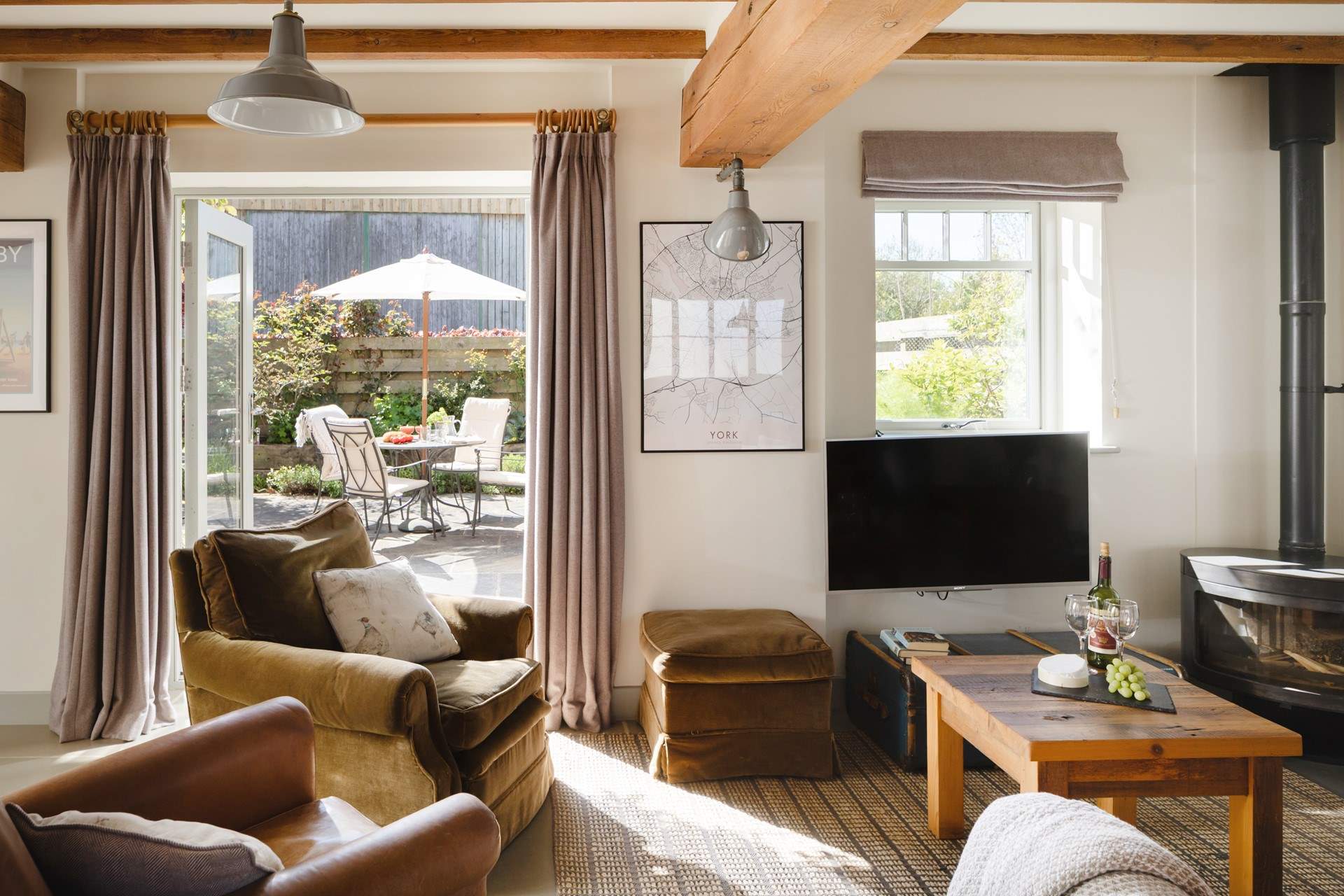 The French windows lead out onto the paved courtyard with delightful borders.