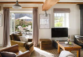 The French windows lead out onto the paved courtyard with delightful borders.