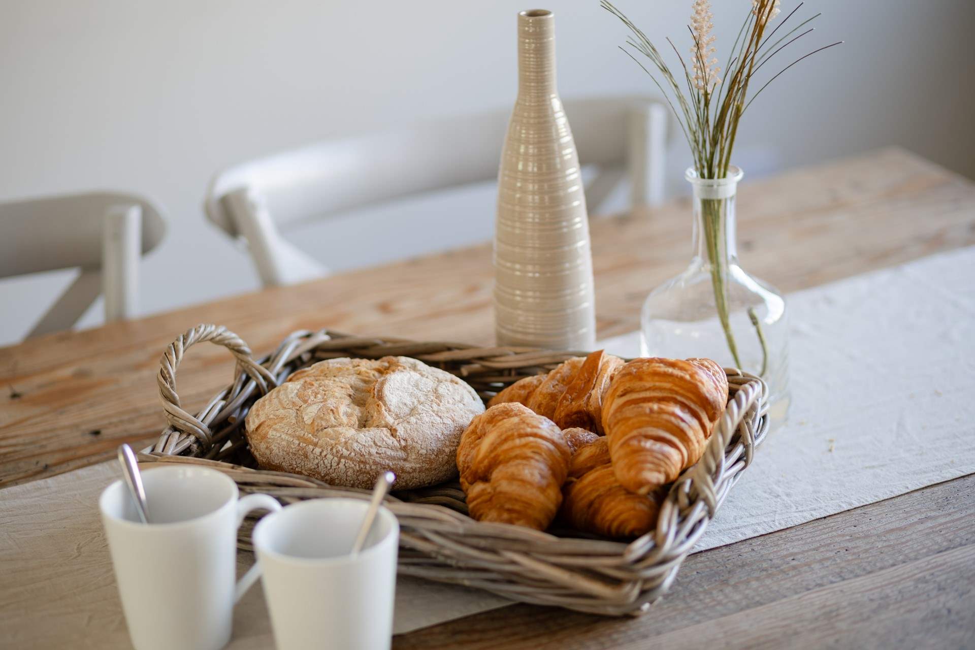 The dining area, with its reclaimed dining-table, is situated next to the kitchen.