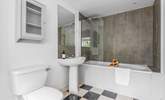 The en suite bathroom to bedroom 1 has a bath with rainfall shower over. - Thumbnail Image