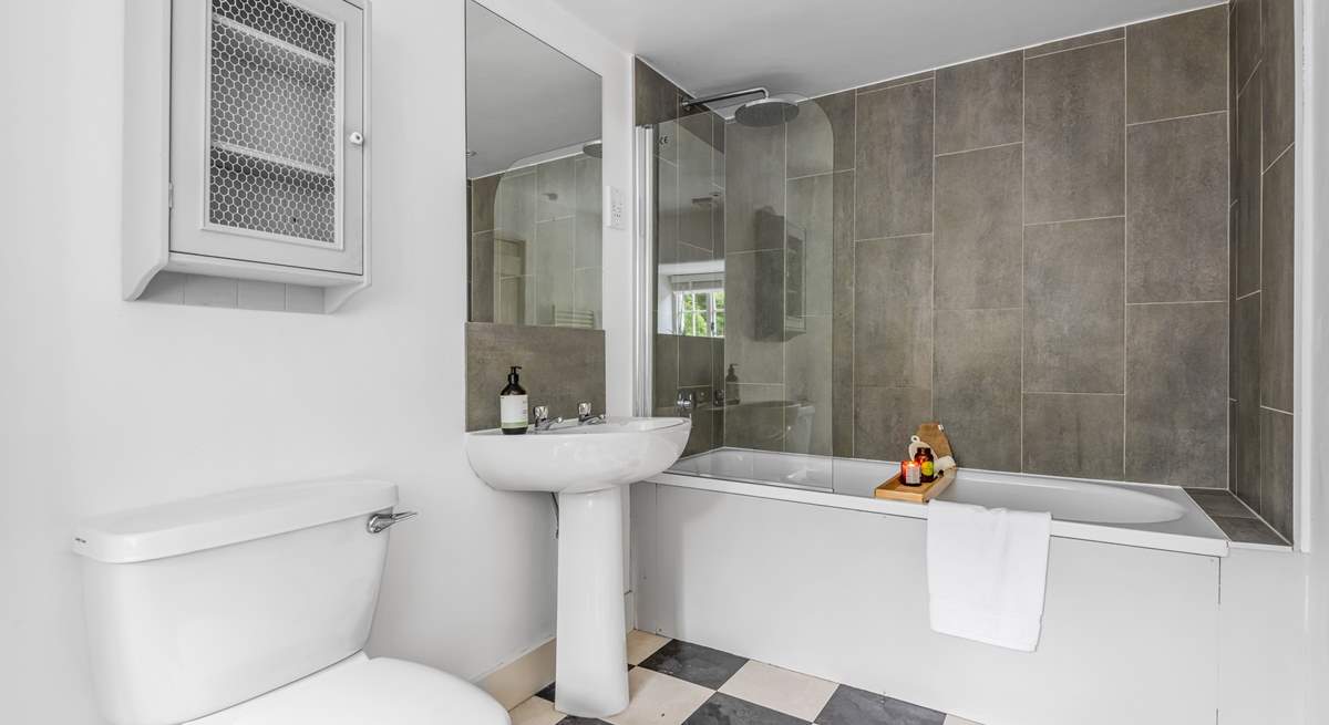 The en suite bathroom to bedroom 1 has a bath with rainfall shower over.