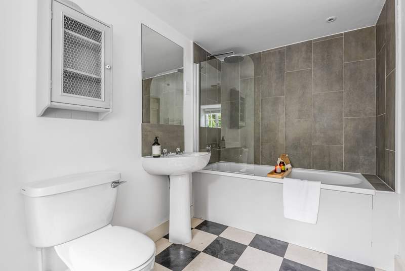 The en suite bathroom to bedroom 1 has a bath with rainfall shower over.