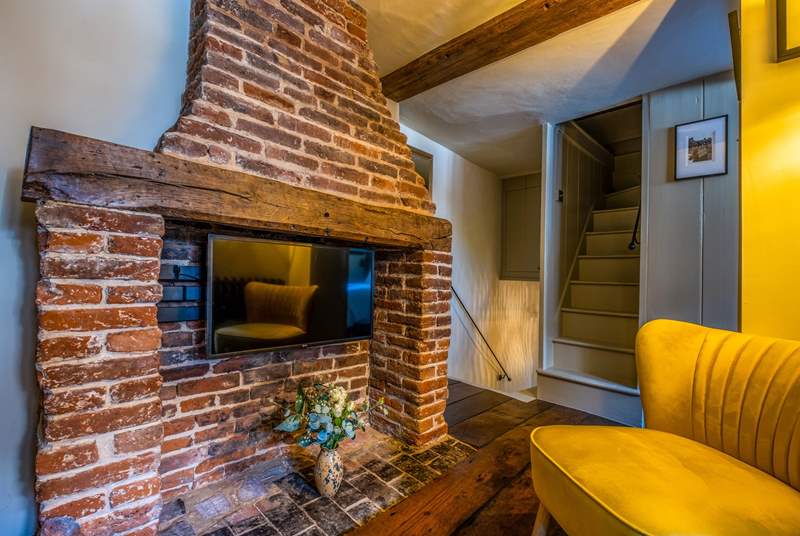 Relax in the cosy snug - stairs lead down to the ground floor (the steeper stairs on the right lead to a private storage area, no access for guests).
