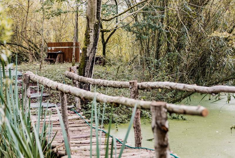 Wander across the bridge to your secluded wood-fired hot tub... such a unique feature! 