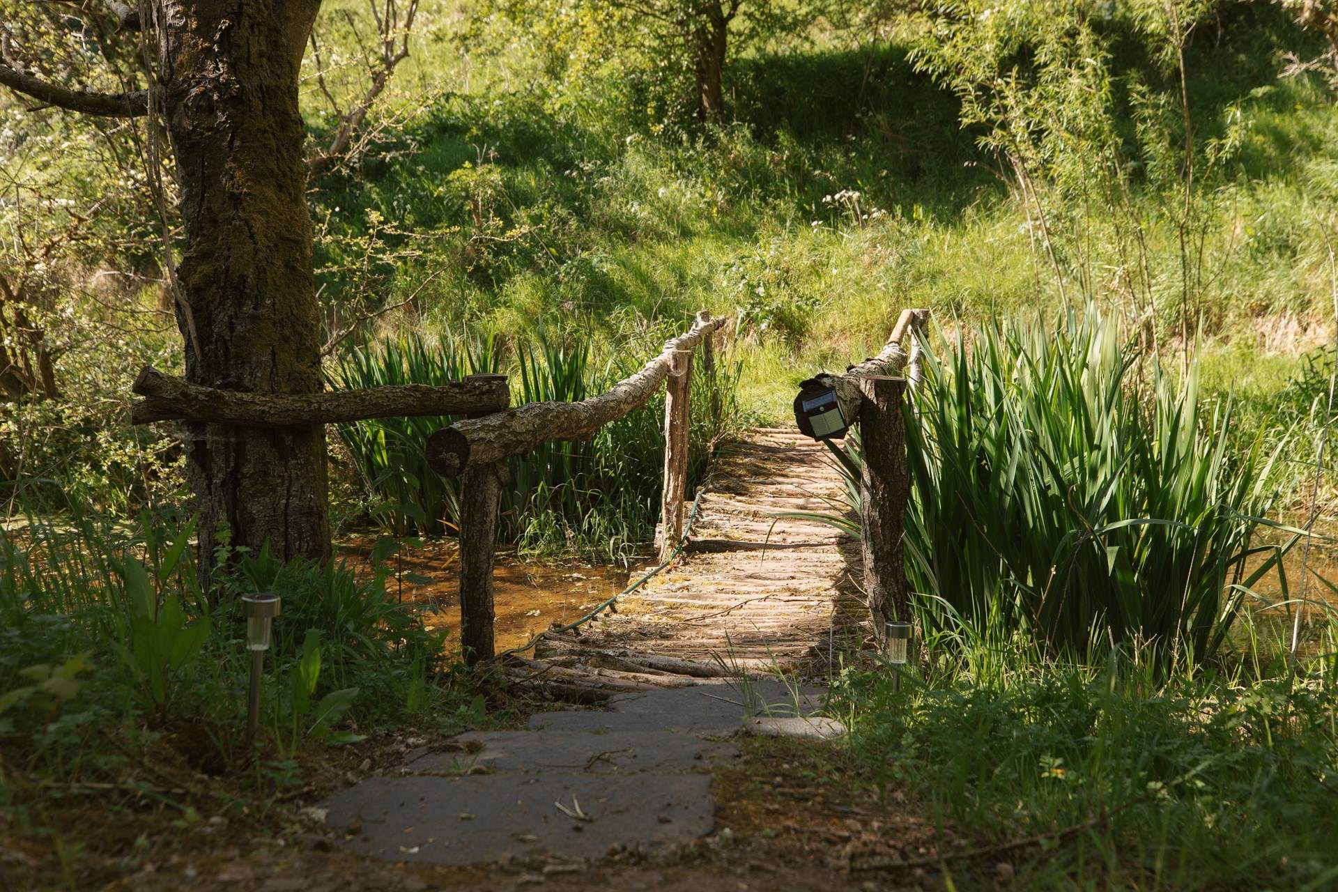 The handcrafted bridge adds so much charm and character to the outside space. 