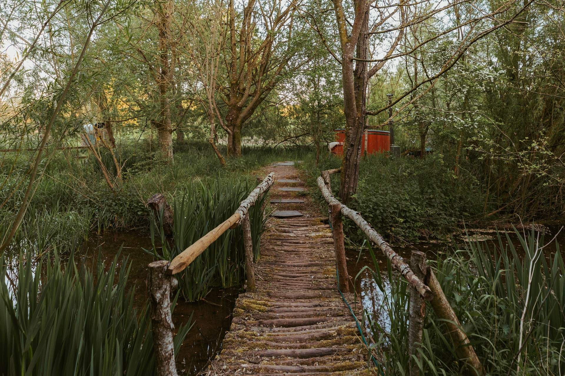 Wander across the bridge to your secluded wood-fired hot tub... 
