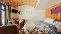 The curved ceiling and wooden panels create the cosiest atmosphere.