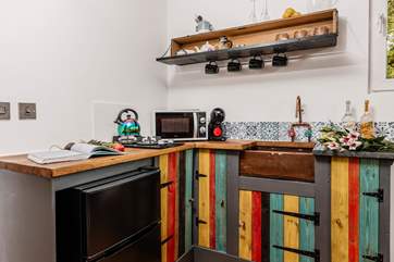The eclectic kitchen is well-equipped with everything you'll need.