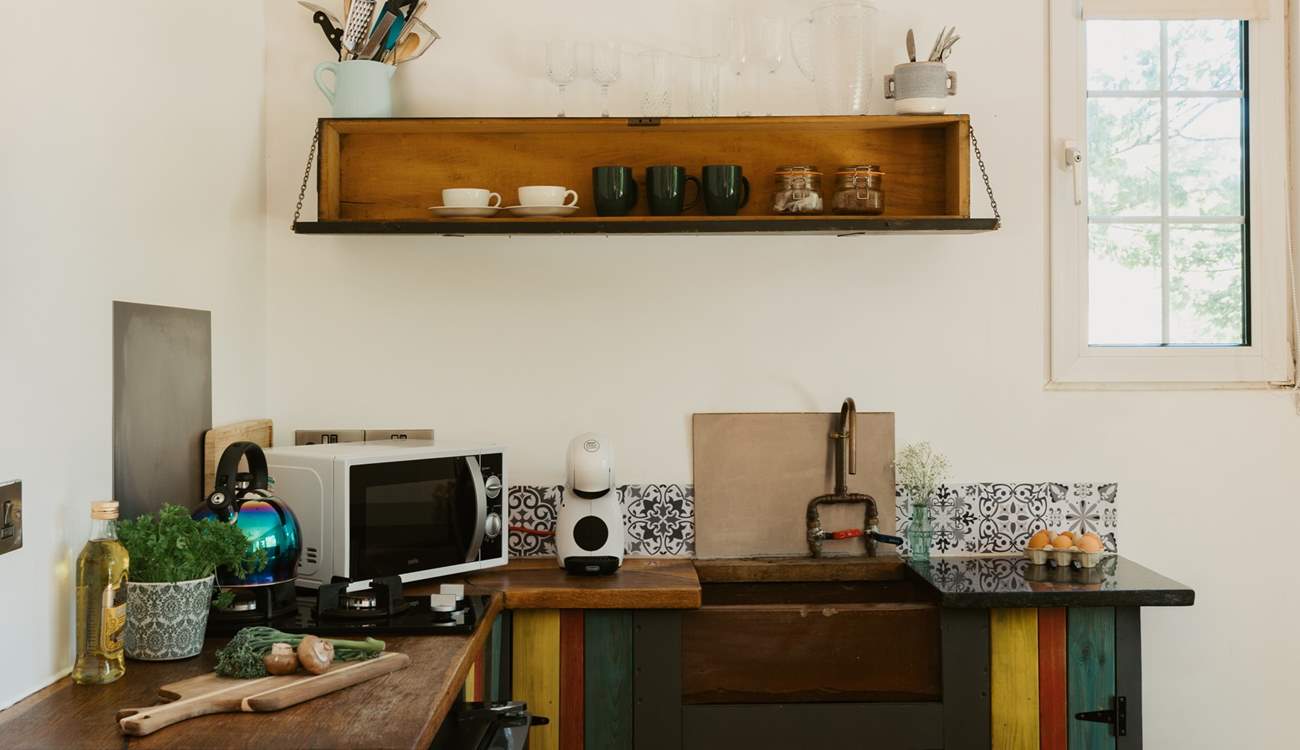 The eclectic kitchen is well-equipped with everything you'll need.  