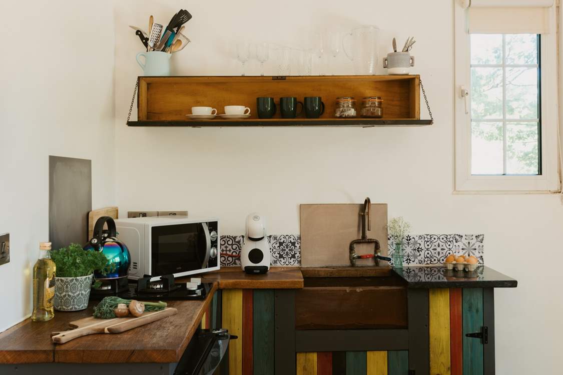 The eclectic kitchen is well-equipped with everything you'll need.