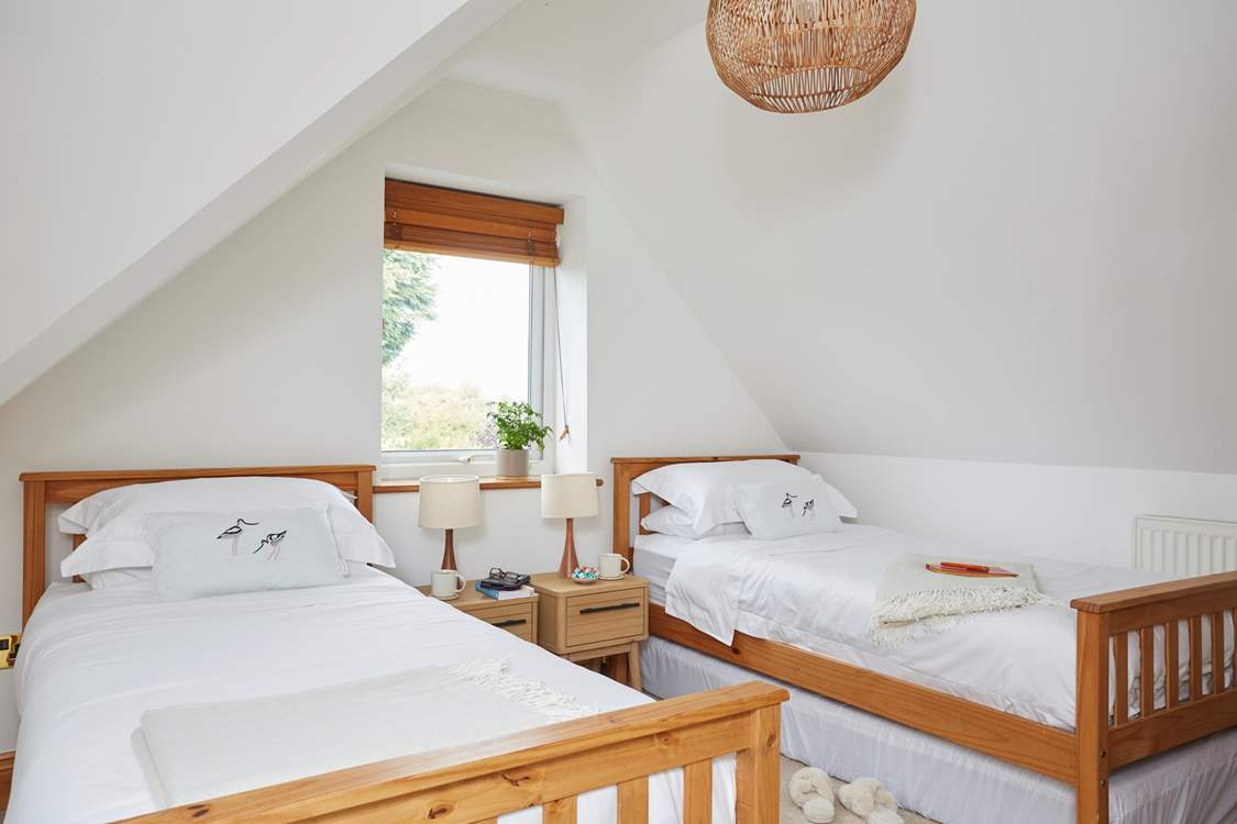 Bedroom two has two single beds with plenty of storage space.