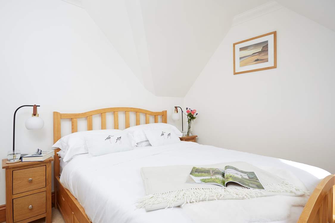 An inviting double king-size bed sits in the centre of bedroom one.