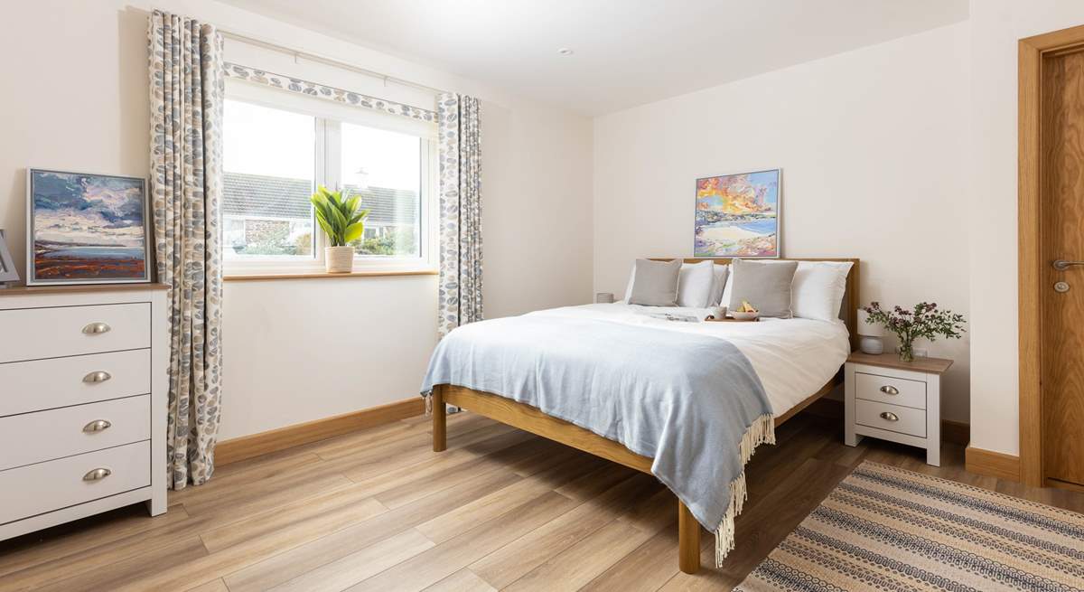 Gorgeous bedroom 1 on the ground floor has a king-size bed and a sleek en suite bathroom.