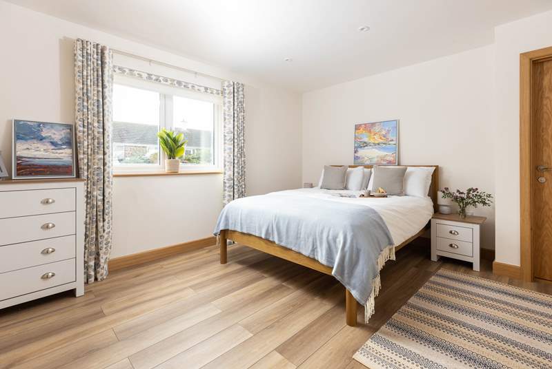Gorgeous bedroom 1 on the ground floor has a king-size bed and a sleek en suite bathroom.