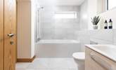 This stylish en suite has a bath with shower over. - Thumbnail Image