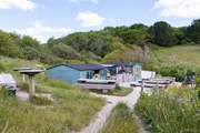 The Hidden Hut sits overlooking Porthcurnick Beach, the perfect spot for a refreshment break.