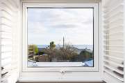 Looking out over the rooftops towards Gull Rock and Gerrans Bay.