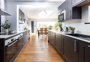 The kitchen leads into the open plan dining area and sitting-room.