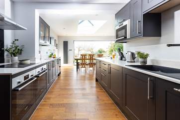 The kitchen leads into the open plan dining area and sitting-room.